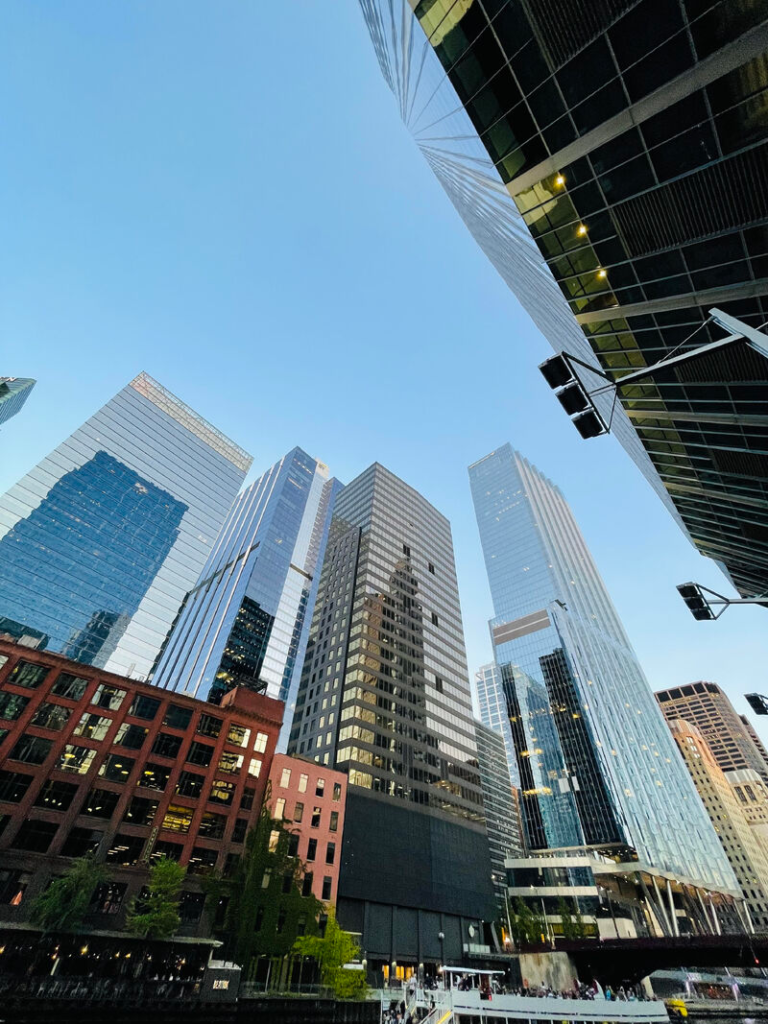 Looking up at glass high-rise buildings from a city street